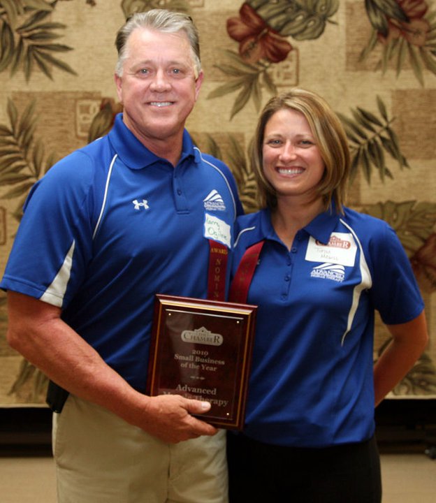 Larry and Trini with award for Advanced Muscle Therapy  in Fernandina Beach, FL